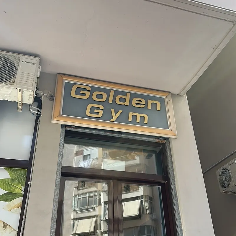 The gold Golden Gym sign above the entrance door